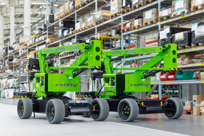 The Niftylift HR10NE and HR10LE prototype boom lifts side by side in the factory