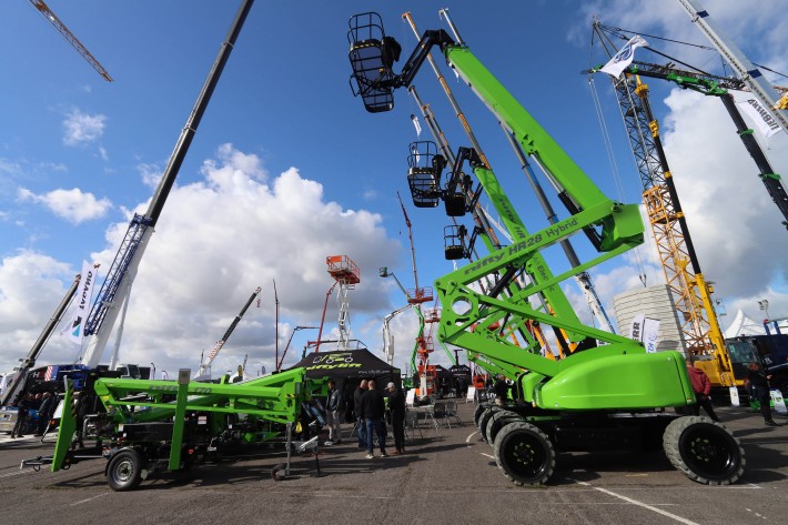 The Niftylift stand at Vertikal Days 2025, Newark Showground The Niftylift stand at Vertikal Days 2025, showing trailer mounted and self-propelled boom lifts with platforms elevated.