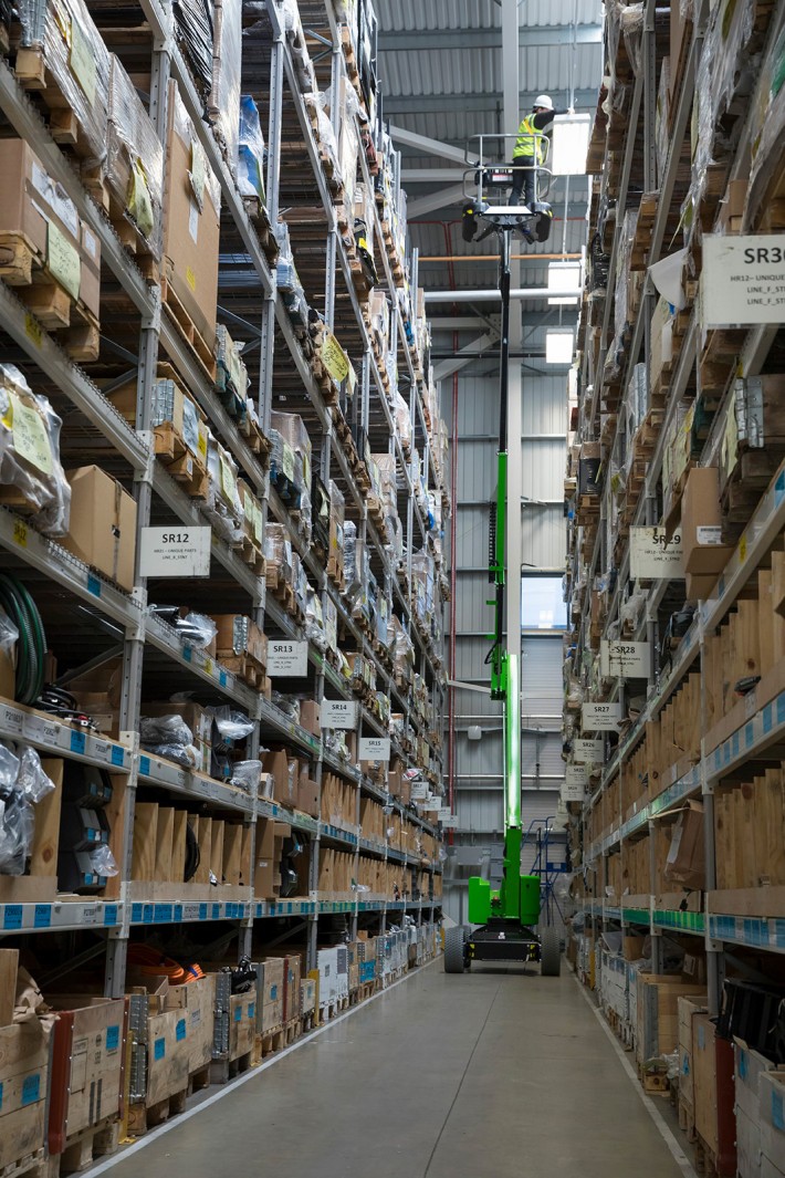 HR12N MK3 narrow aisle operation HR12N MK3 working at height in a narrow warehouse aisle.